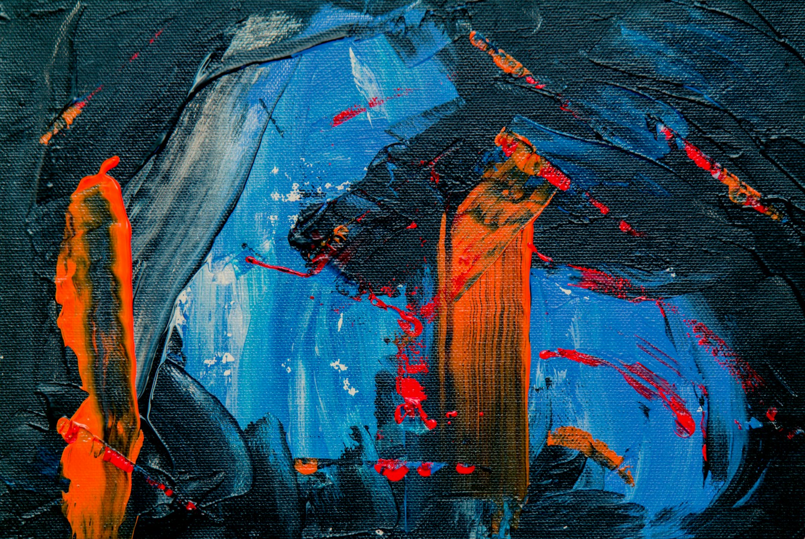 Photo by Rubidium Beach blue, black, and orange abstract painting