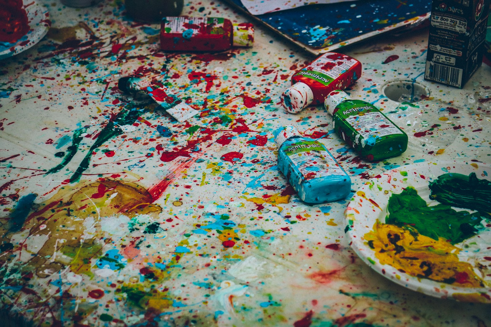 Photo by Ricardo Viana assorted-color bottles on white surface with paint scribbles